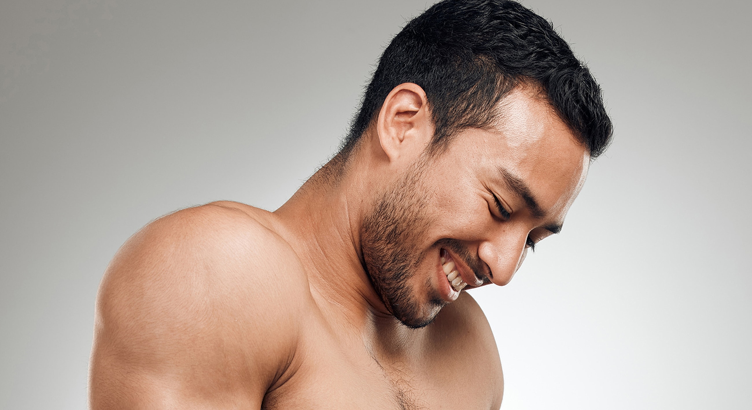 Smiling man with athletic build and short hair.